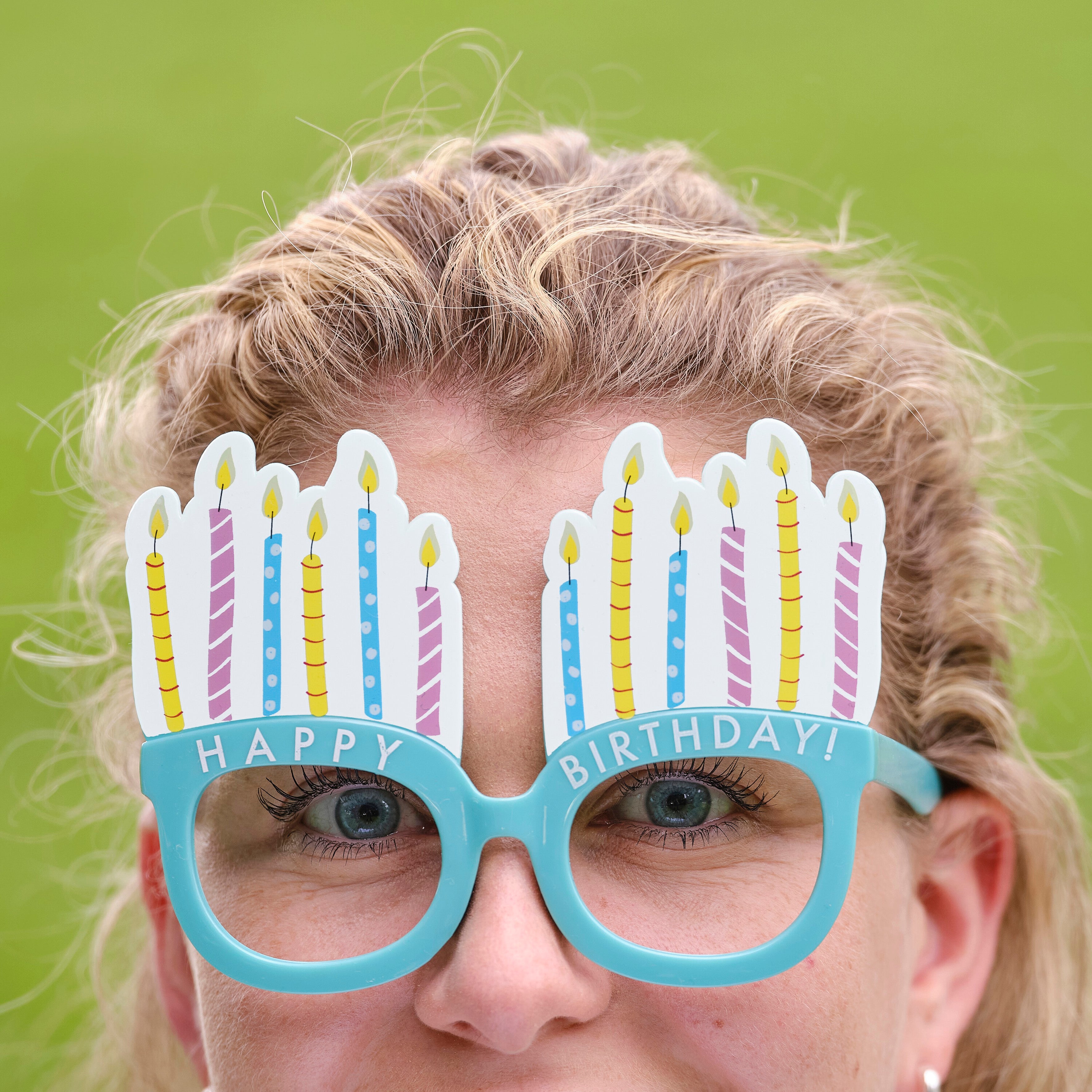 Funny birthday glasses with colorful candles